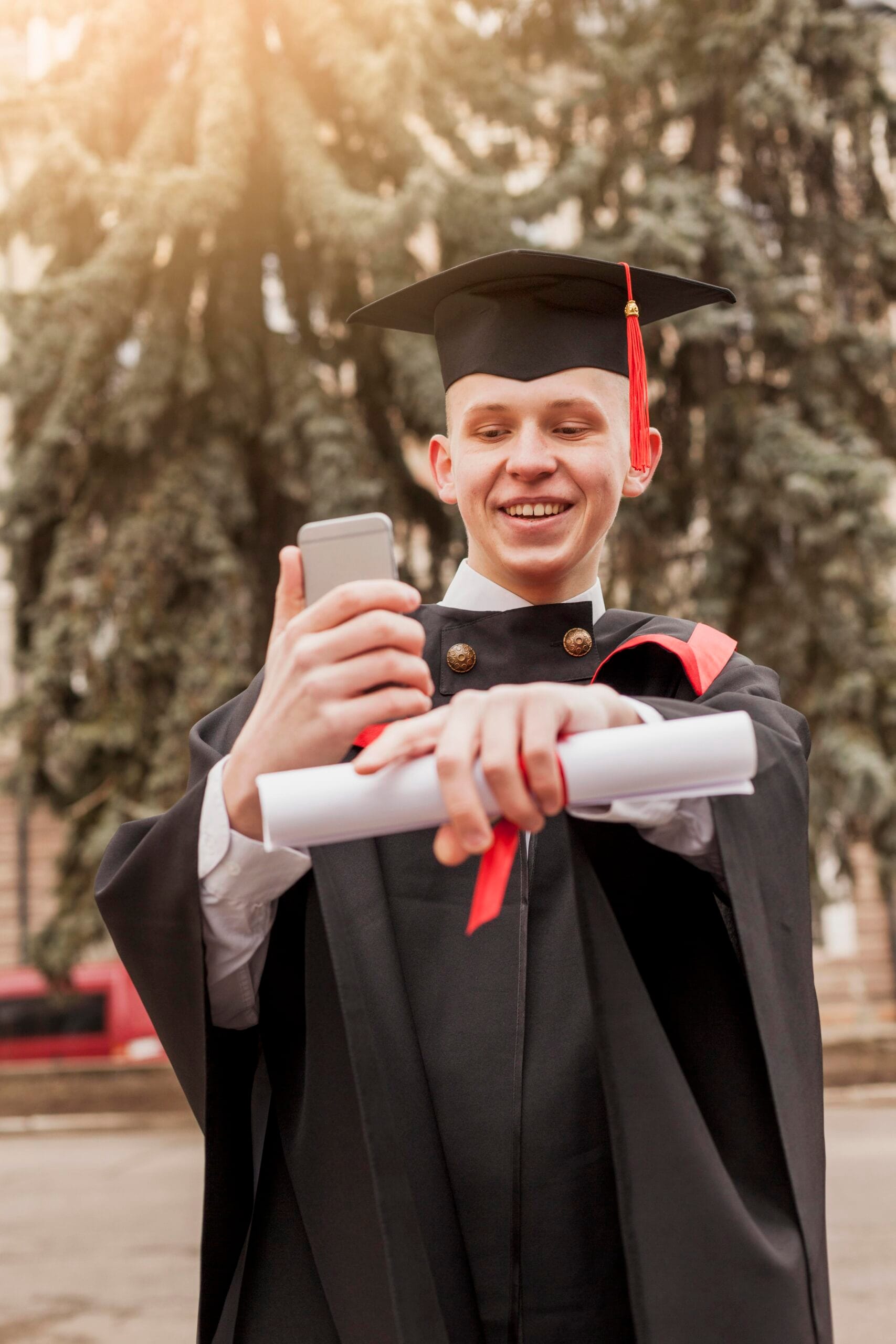 smiley-graduated-boy-with-mobile